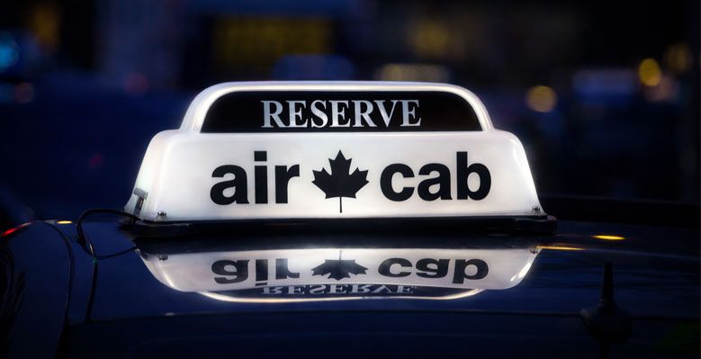 Illuminated Air Cab Reserve roof sign reflected on a premium vehicle